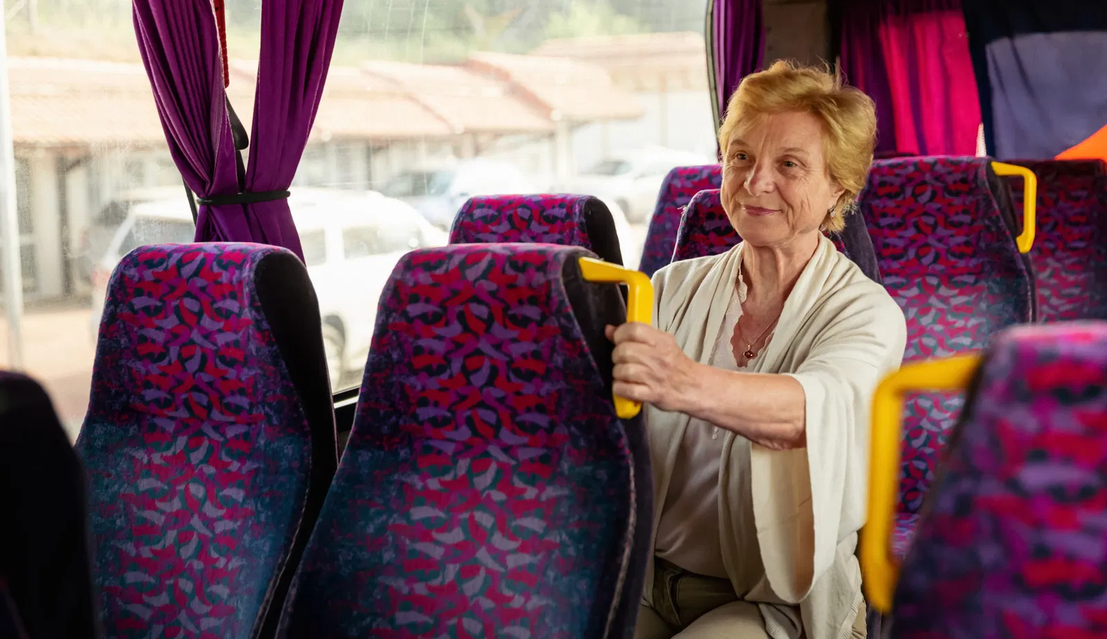 Senior Woman sitting in a travel bus.