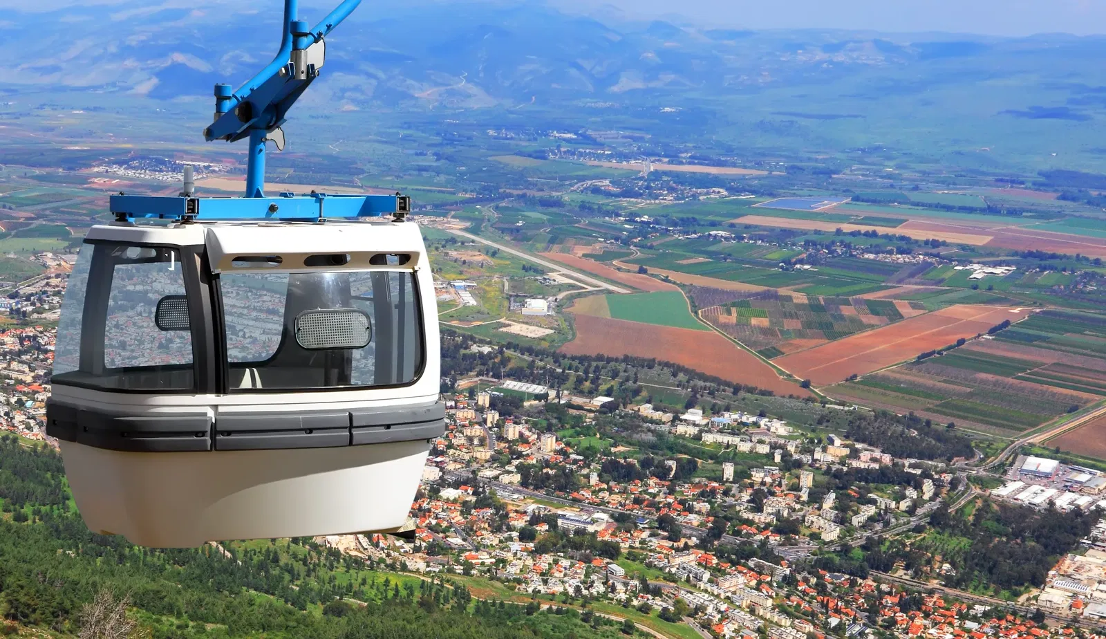 A photograph of a cable car overlooking Kiryat Shmona.